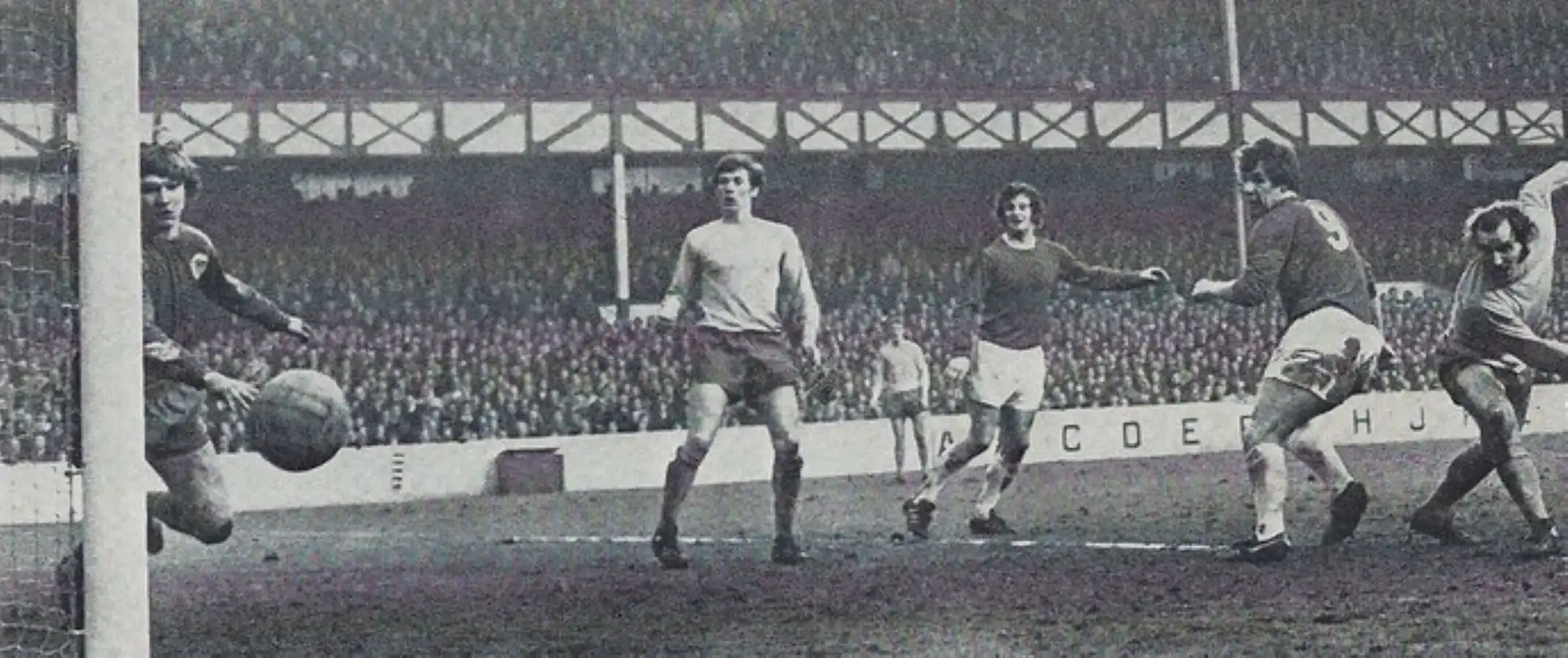 1715 06.02.71 Royle v Huddersfield - LAST IN SEQUENCE - Joe Royle meets a chip from Colin Har...webp