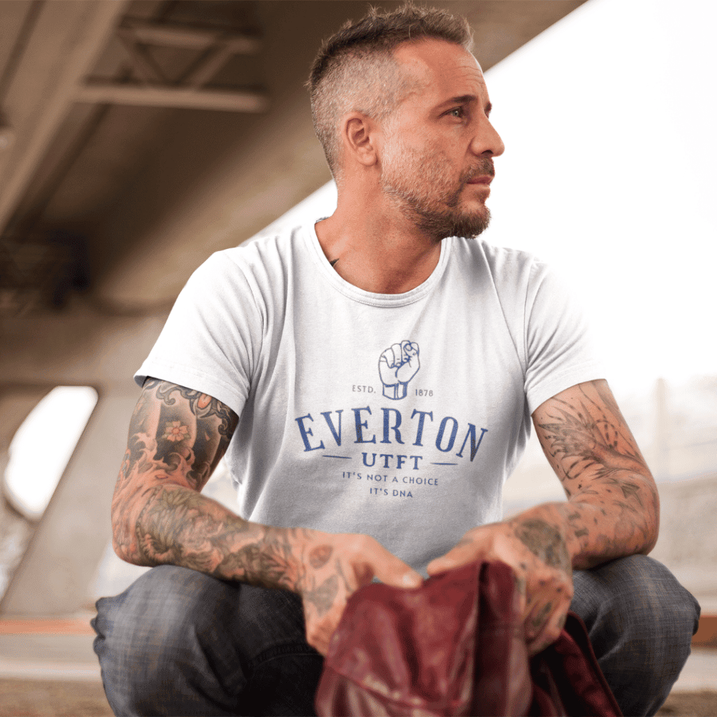 everton-dna-white-middle-aged-man-tattoos-sitting-staring-left.png