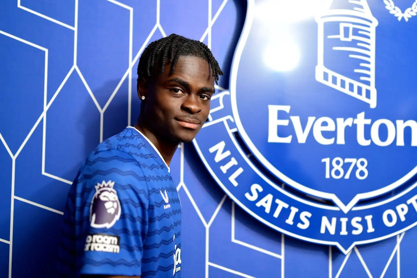 Tyrique George stood beside the Everton crest