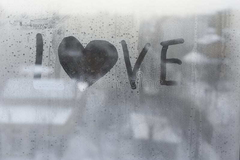 valentine-s-day-concept-word-love-shape-heart-drawn-finger-glass-condensation-window-against-b...jpg