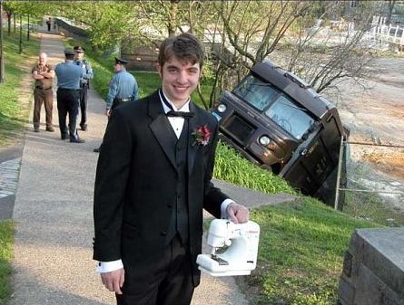 guy-holding-sewing-machine-in-front-of-crashed-ups-truck.jpg
