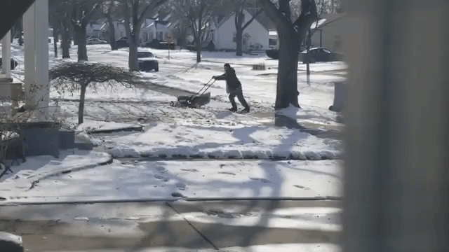 michigan-man-tries-to-mow-his-lawn-that-is-covered-in-snow.gif