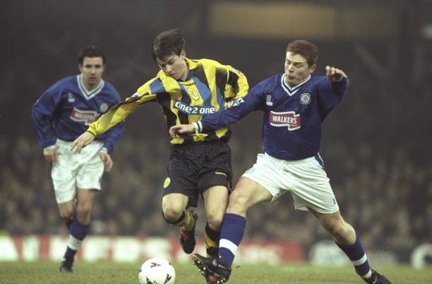 dec-1997-john-oster-of-everton-is-challenged-by-neil-lennon-of-city-picture-id1629715